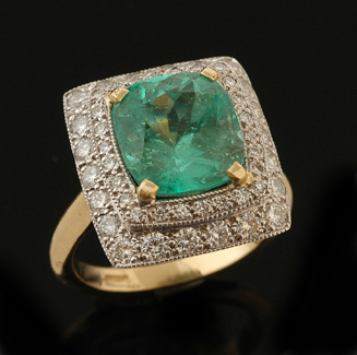 Appraisal: An emerald and diamond ring The rectangular cluster centrally set