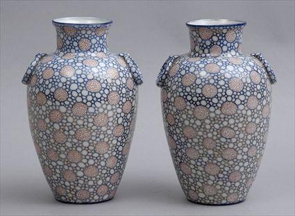 Appraisal: PAIR OF CHINOISERIE MOLDED PORCELAIN OVOID VASES Each with molded