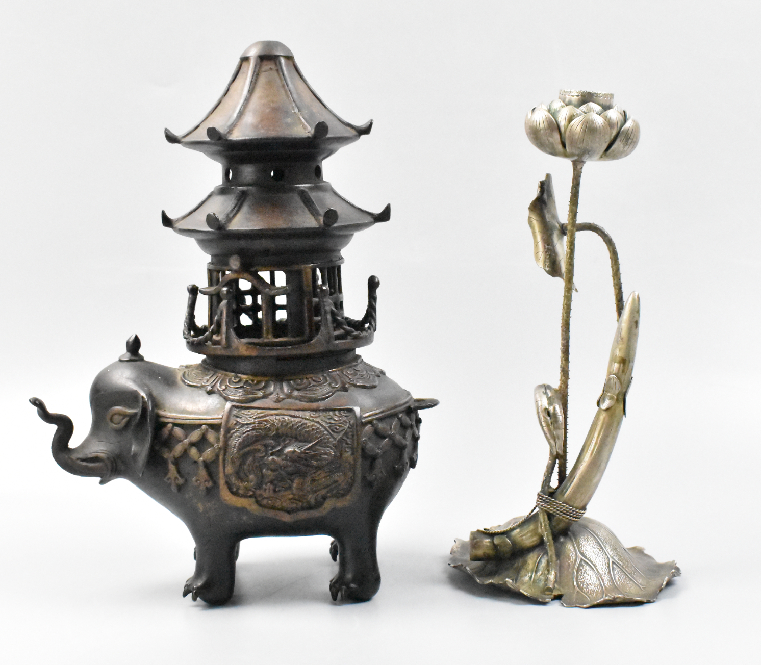 Appraisal: A Japanese bronze elephant form censer and brass candle stick