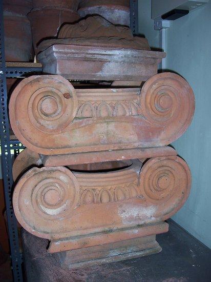 Appraisal: A pair of terracotta capitals cm wide and a lion