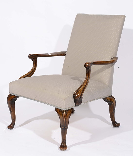 Appraisal: A George III style walnut armchairwith swept arms upholstered seat