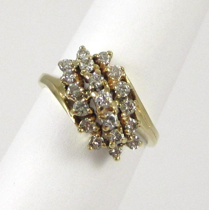 Appraisal: DIAMOND AND FOURTEEN KARAT GOLD RING set with a cluster