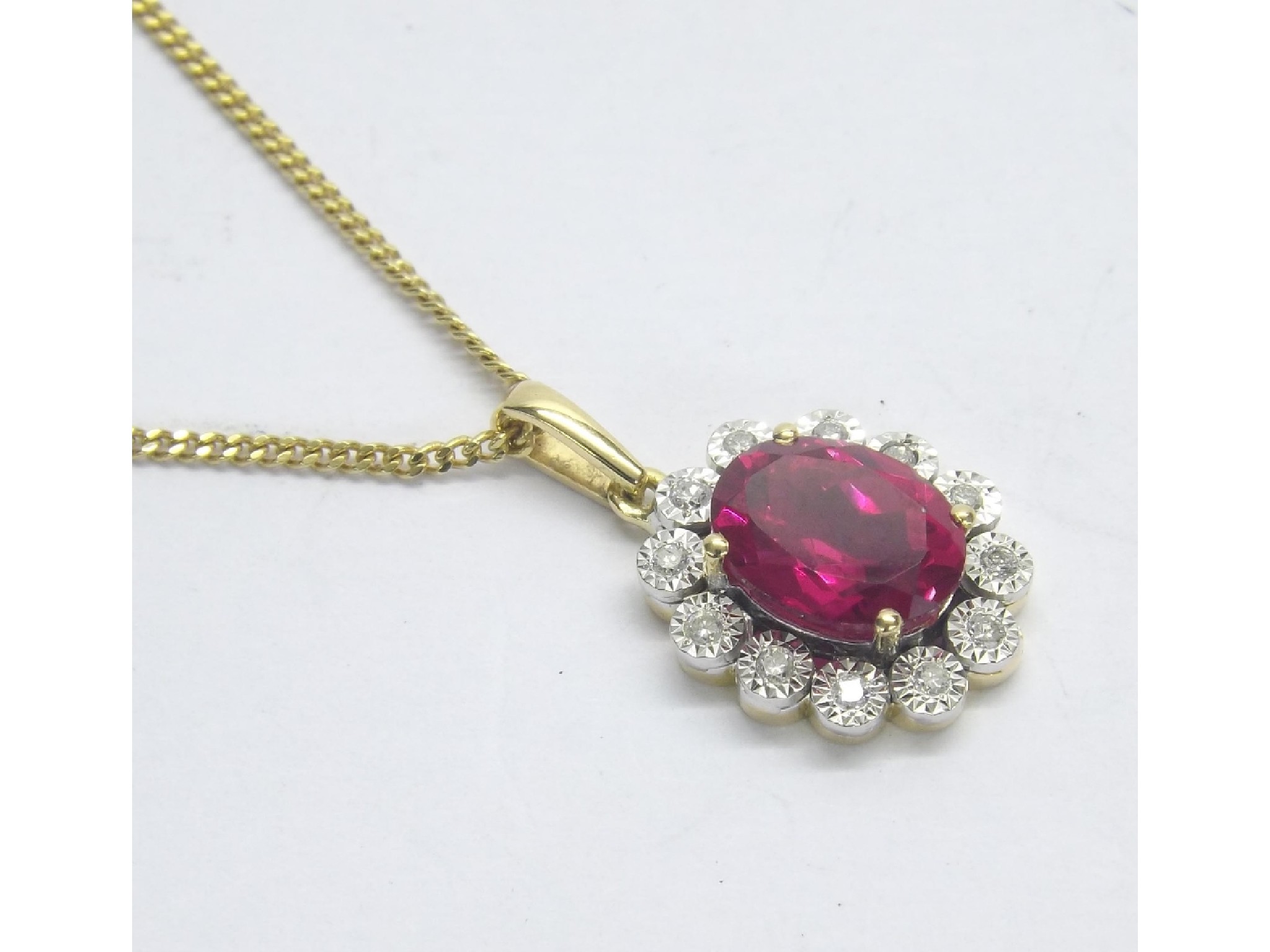 Appraisal: ct ruby and diamond oval cluster pendant on a slender