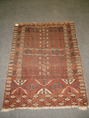 Appraisal: An Afghan rug with geometric hooked motifs in deep brown