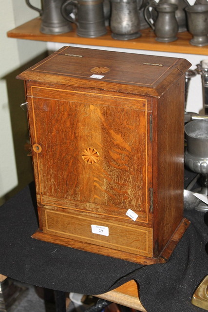 Appraisal: AN EDWARDIAN OAK SMOKERS CABINET with fitted interior and inlaid