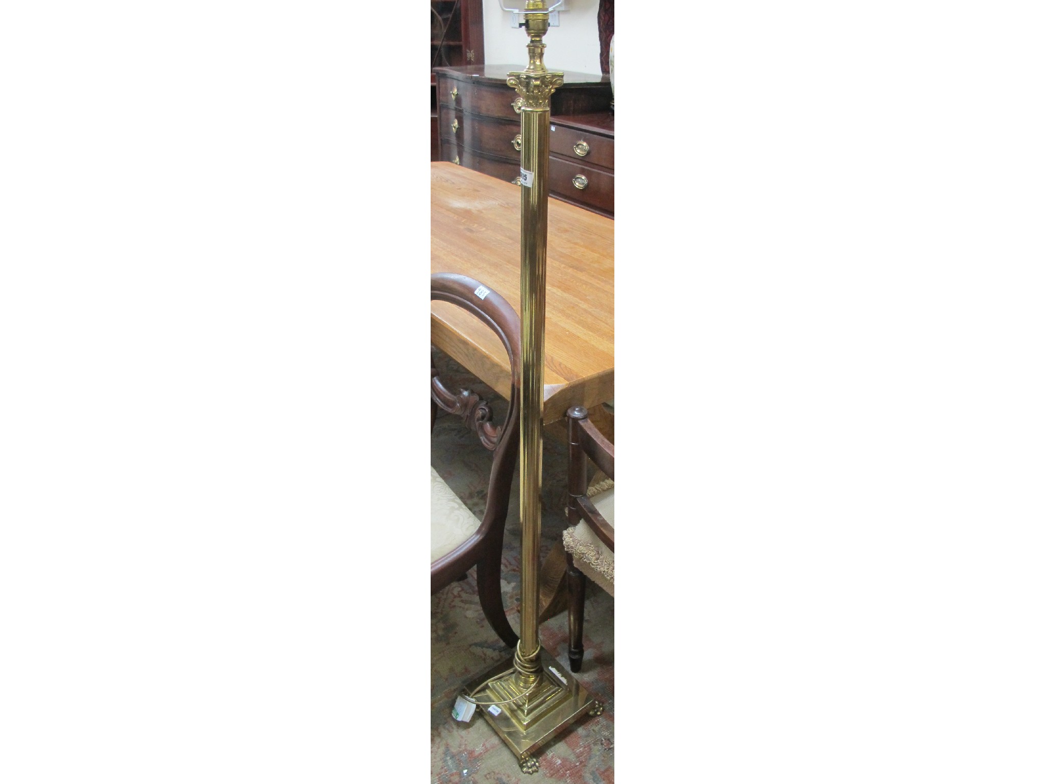 Appraisal: A brass standard lamp with lion feet