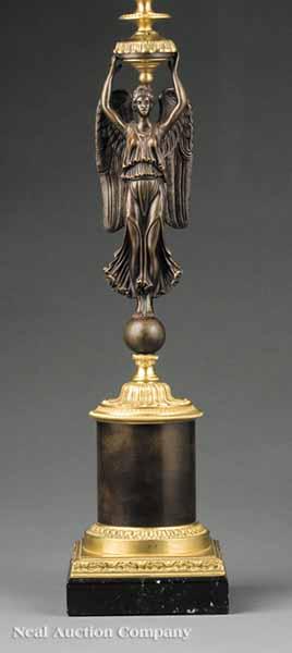 Appraisal: An Empire-Style Patinated and Polished Bronze Figural Table Lamp having