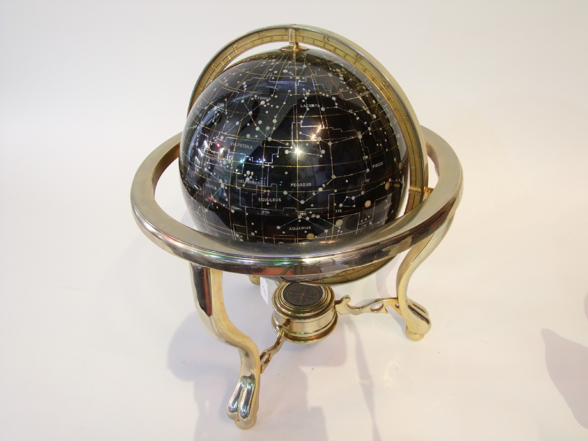 Appraisal: A celestial globe mapping the constellations the black ground detailed