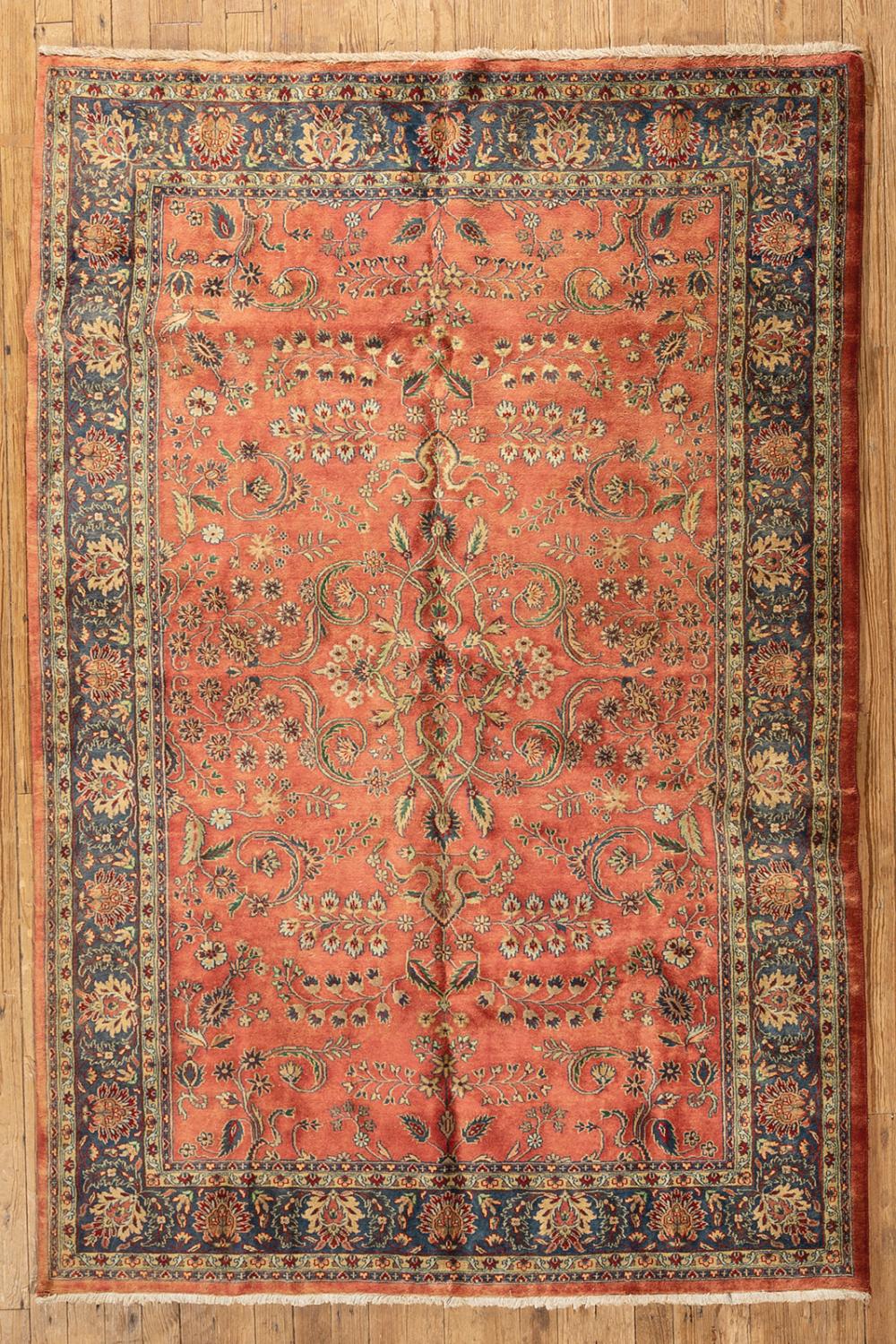 Appraisal: Persian Carpet red ground blue border vining foliate design ft