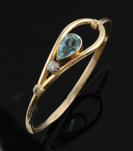 Appraisal: An aquamarine and diamond bangle The ct gold hinged bangle