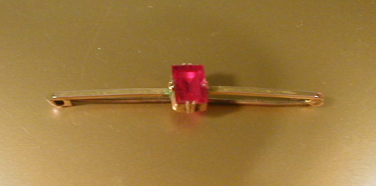 Appraisal: A ct gold bar brooch set with a single ruby