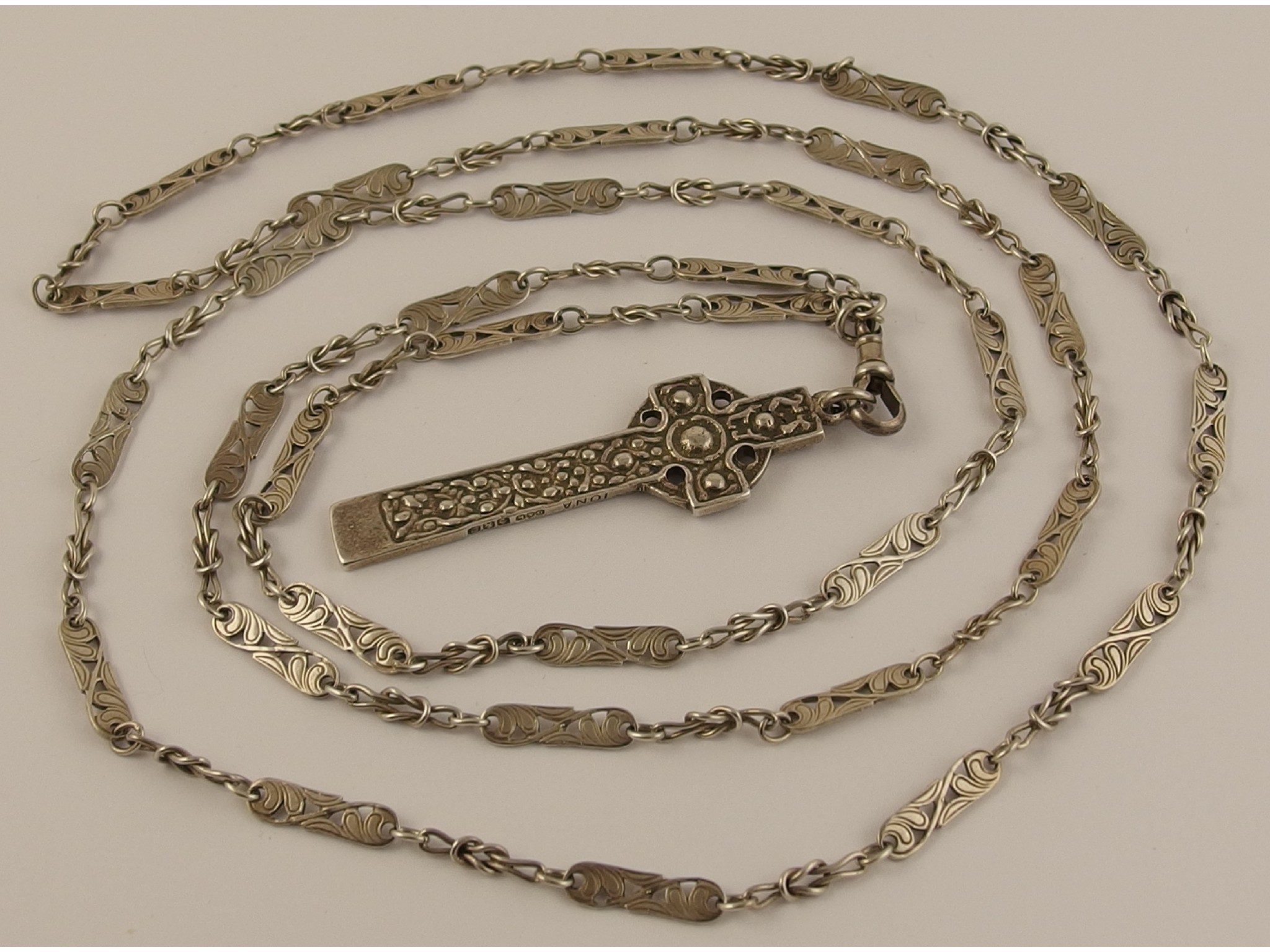 Appraisal: A St Martin's cross pendant and floral decorative chain by