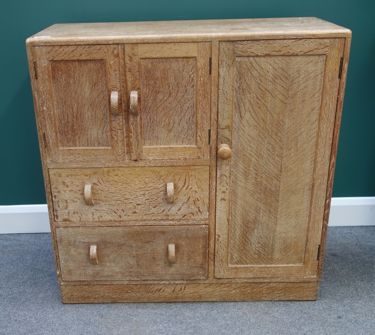 Appraisal: A Heals limed oak side cabinet with an arrangement of