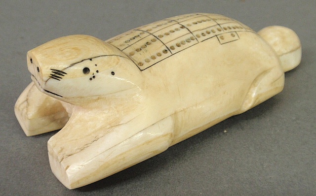 Appraisal: - Inuit cribbage board th c carved in the form