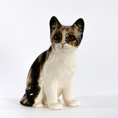 Appraisal: Winstanley Kensington Pottery a model of a seated cat painted