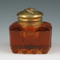 Appraisal: Amber glass ink well with brass lid and applied cherub