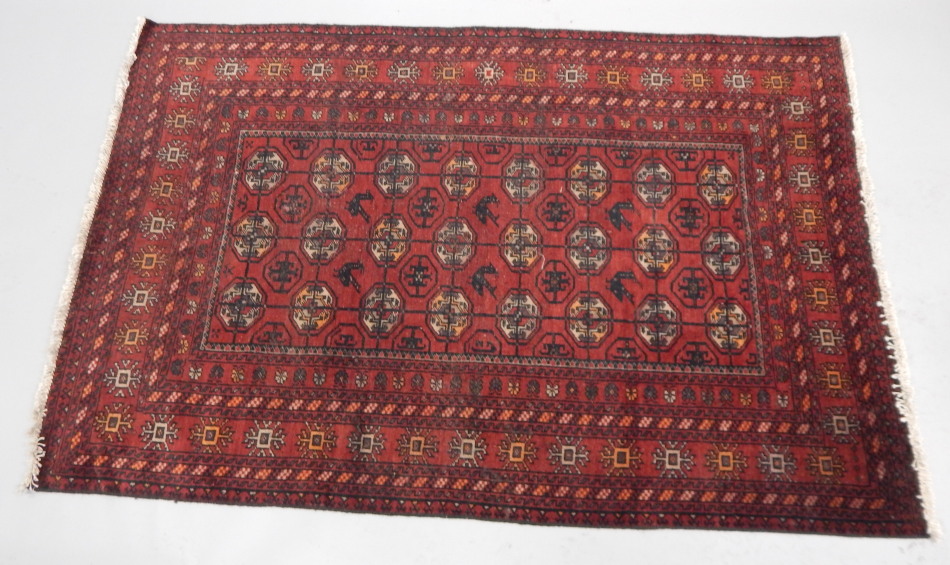 Appraisal: A Turkoman style rug of geometric floral pattern predominately in