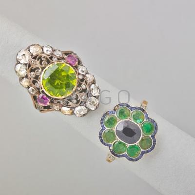 Appraisal: TWO JEWELED GOLD CLUSTER RINGS Emerald and sapphire oval cluster