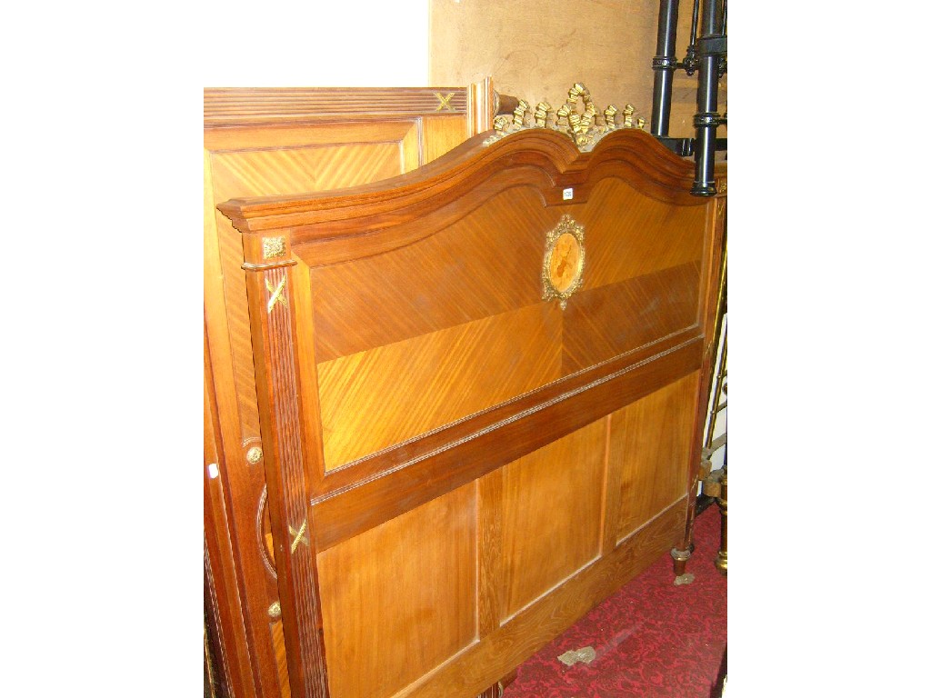 Appraisal: A continental walnut double bedstead with shaped outline enclosing well