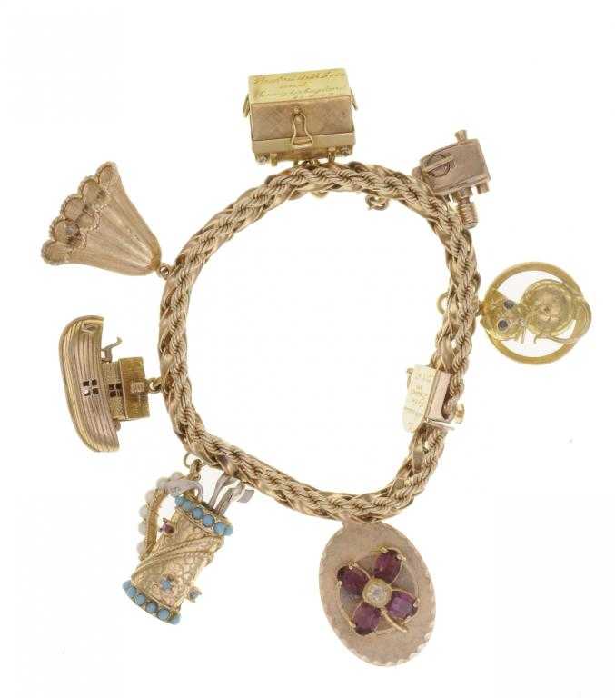 Appraisal: A GOLD CHARM BRACELET the plaited ribbon edged with rope