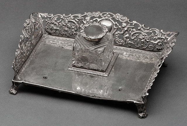 Appraisal: A VICTORIAN SILVER DESK STAND with three pierced sides decorated