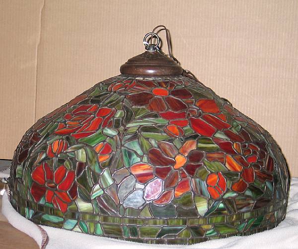 Appraisal: A Tiffany style leaded slag glass and patinated bronze hanging