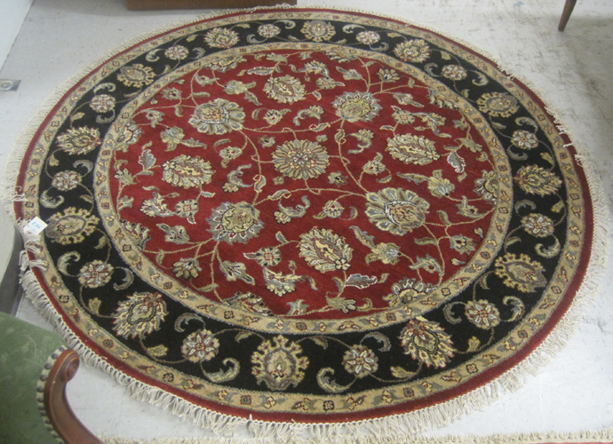 Appraisal: ROUND ORIENTAL AREA RUG Indo-Persian overall floral design on madder