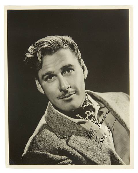 Appraisal: An Errol Flynn signed black and white photograph s A