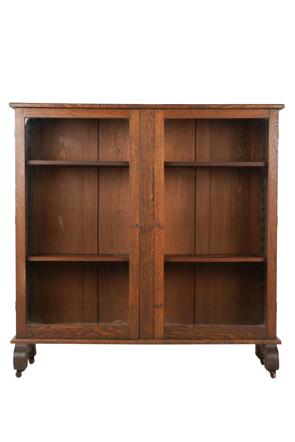 Appraisal: AMERICAN OAK BOOKCASElate th early th century with two hinged