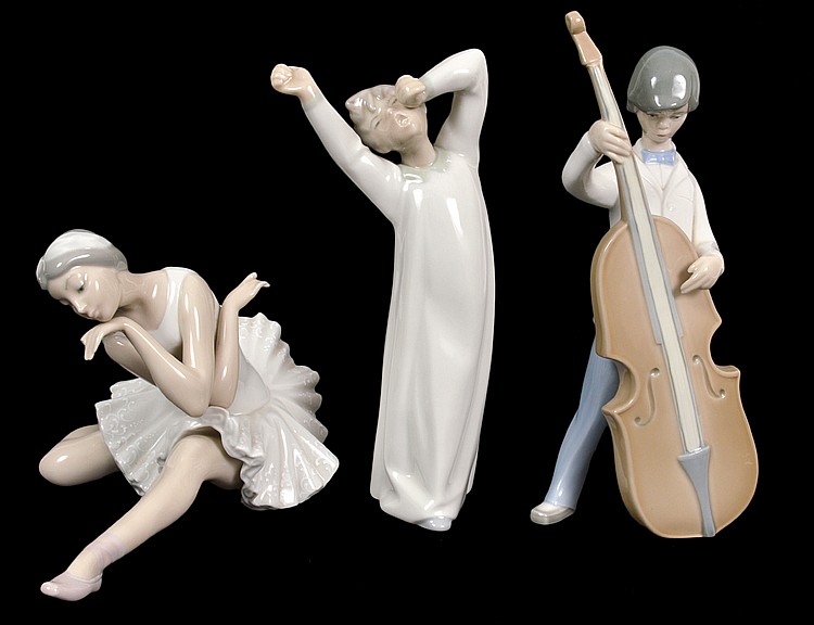 Appraisal: THREE LLADRO PORCELAIN FIGURAL GROUPSMarked Comprising a boy cellist a