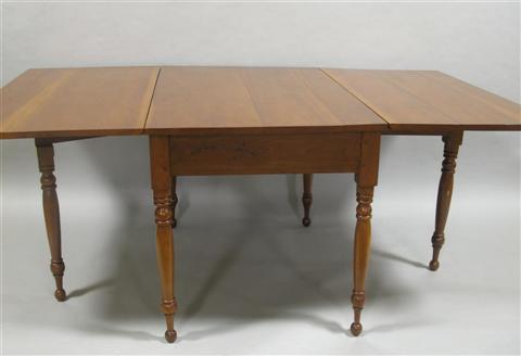 Appraisal: AMERICAN SHERATON CHERRY DROP LEAF TABLE rectangular center panel flanked