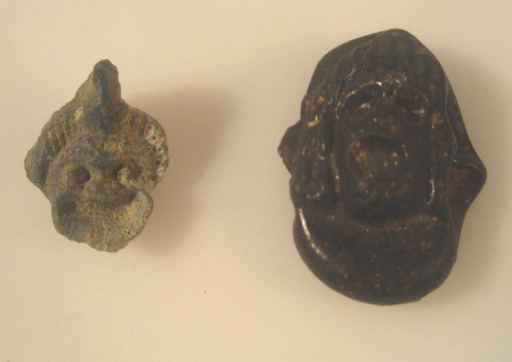 Appraisal: A turquoise-blue impressed glass pendant with a Greek theatrical mask