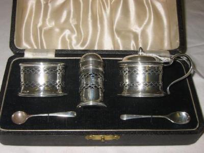 Appraisal: A THREE PIECE CRUET SET of cylindrical form pierced with