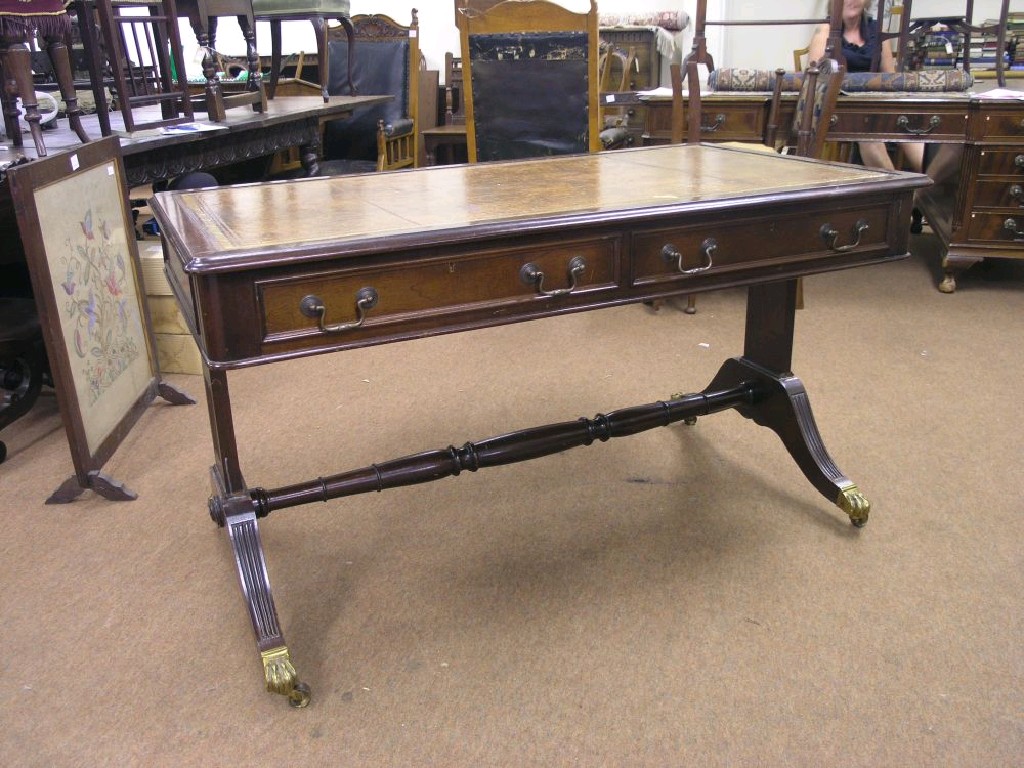 Appraisal: A Regency style mahogany library table with inset gilt-tooled brown