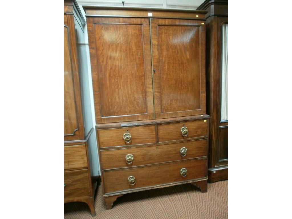 Appraisal: A Georgian mahogany press cupboard with step frieze two panelled