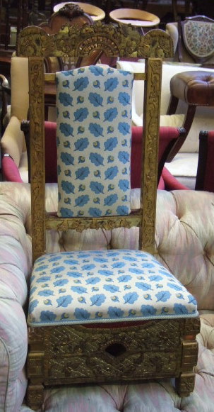 Appraisal: Two similar carved and giltwood low chairs Eastern possibly Tibetan