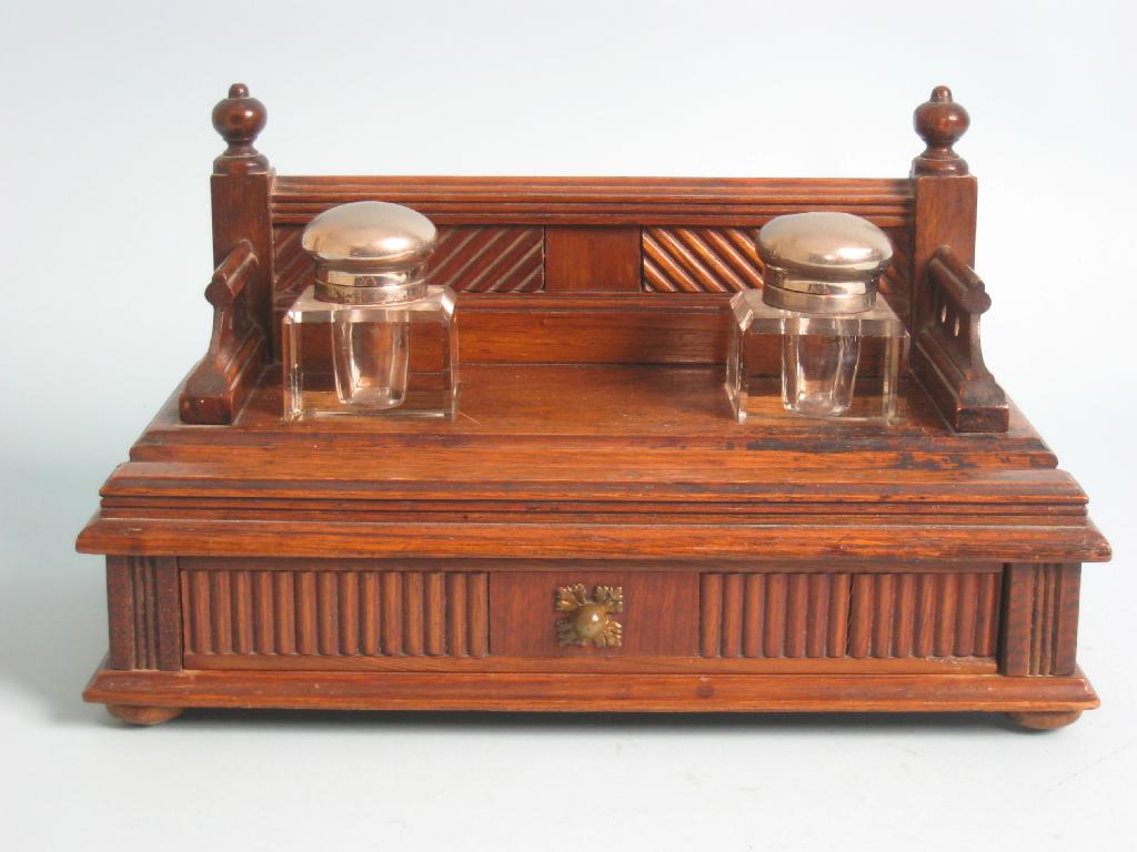 Appraisal: An aesthetic movement oak Inkstand with raised gallery having turned