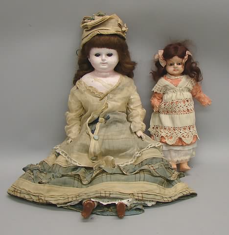 Appraisal: Pair of papier mache dolls with stationary glass eyes Has