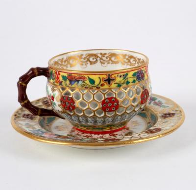 Appraisal: A Chamberlains Worcester reticulated double-walled teacup and plate in the