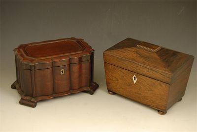 Appraisal: A Victorian rosewood sarcophagus shape tea caddy with a twin