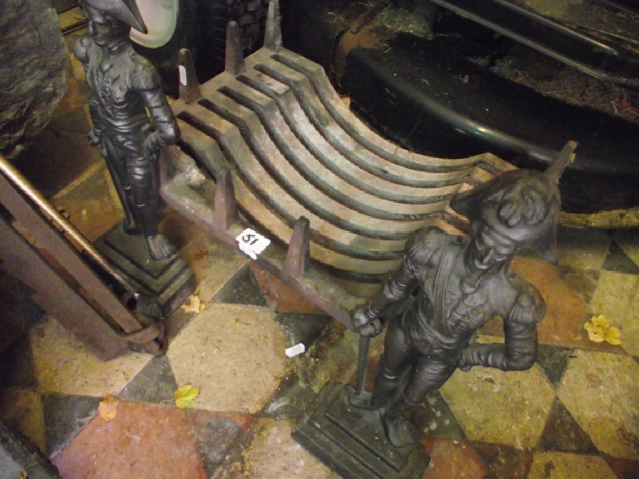 Appraisal: A small cast iron fire basket raised on a pair