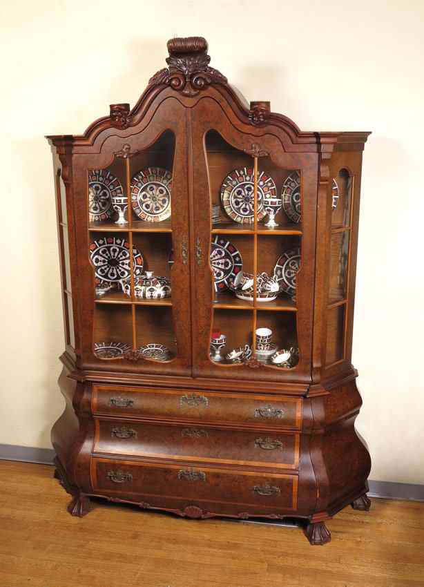 Appraisal: BOMBAY BURL CHINA CABINET Burl veneer carved crest over shaped