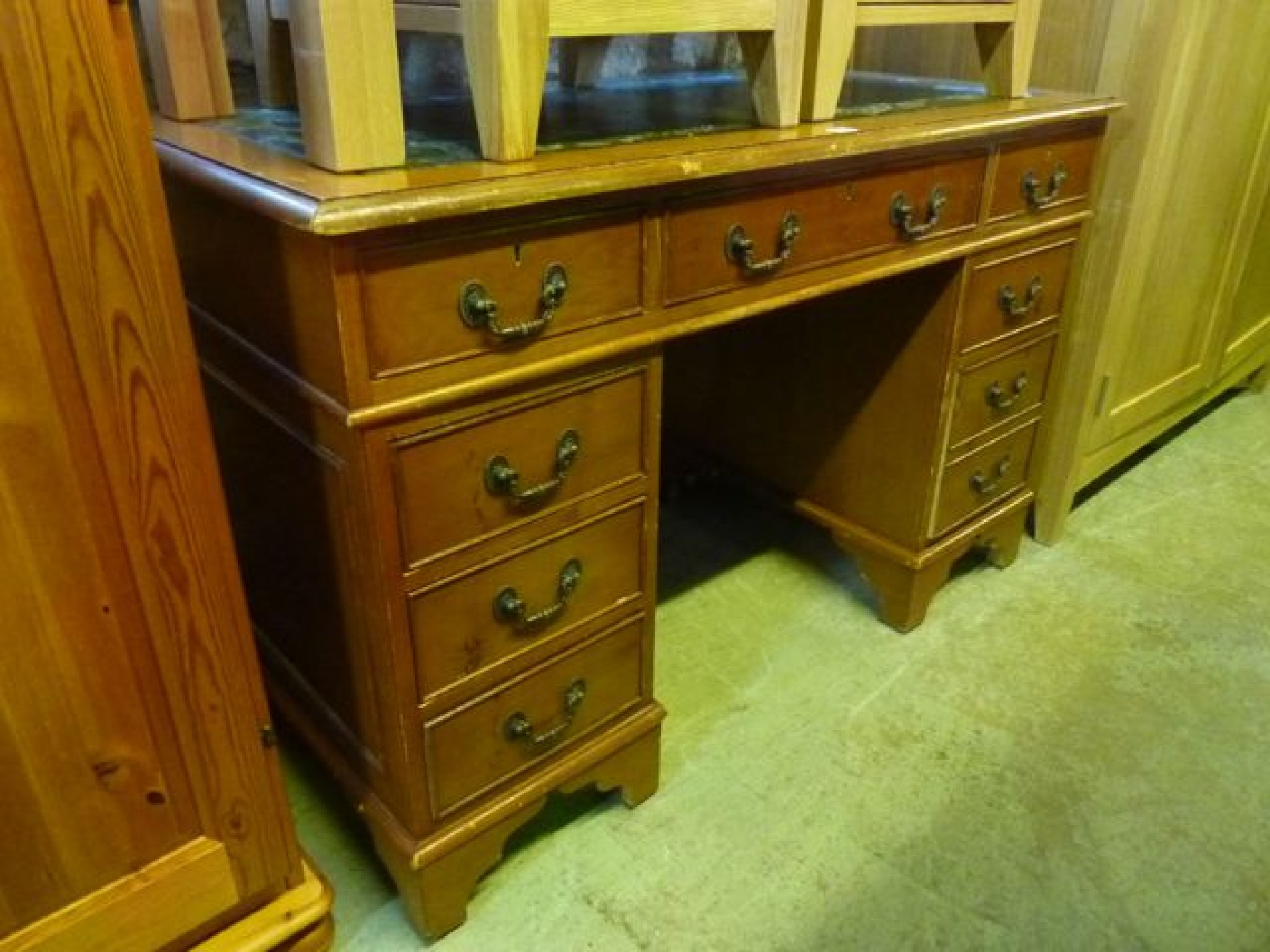 Appraisal: A reproduction yew wood veneered kneehole twin pedestal writing desk