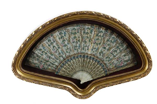 Appraisal: A painted silk and carved tinted ivory fan framed dimensions