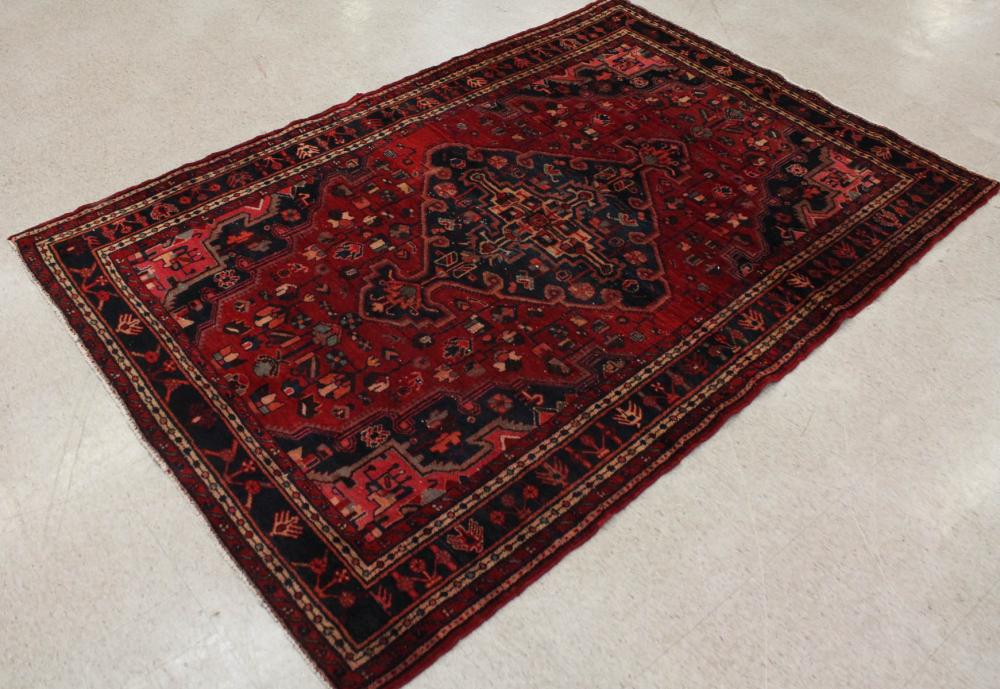 Appraisal: HAND KNOTTED PERSIAN AREA RUG stylized floral and central medallion