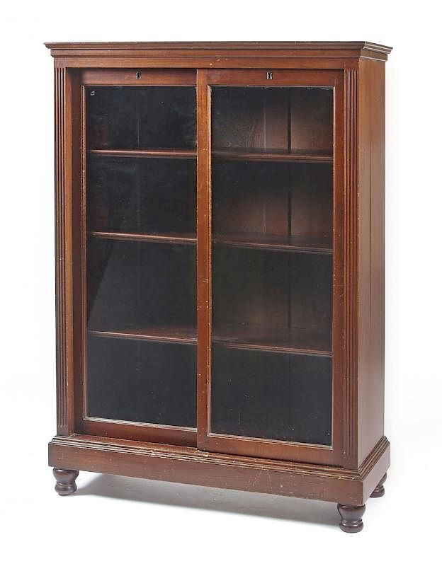 Appraisal: Mahogany bookcase with sliding glass doors Mahogany bookcase with sliding