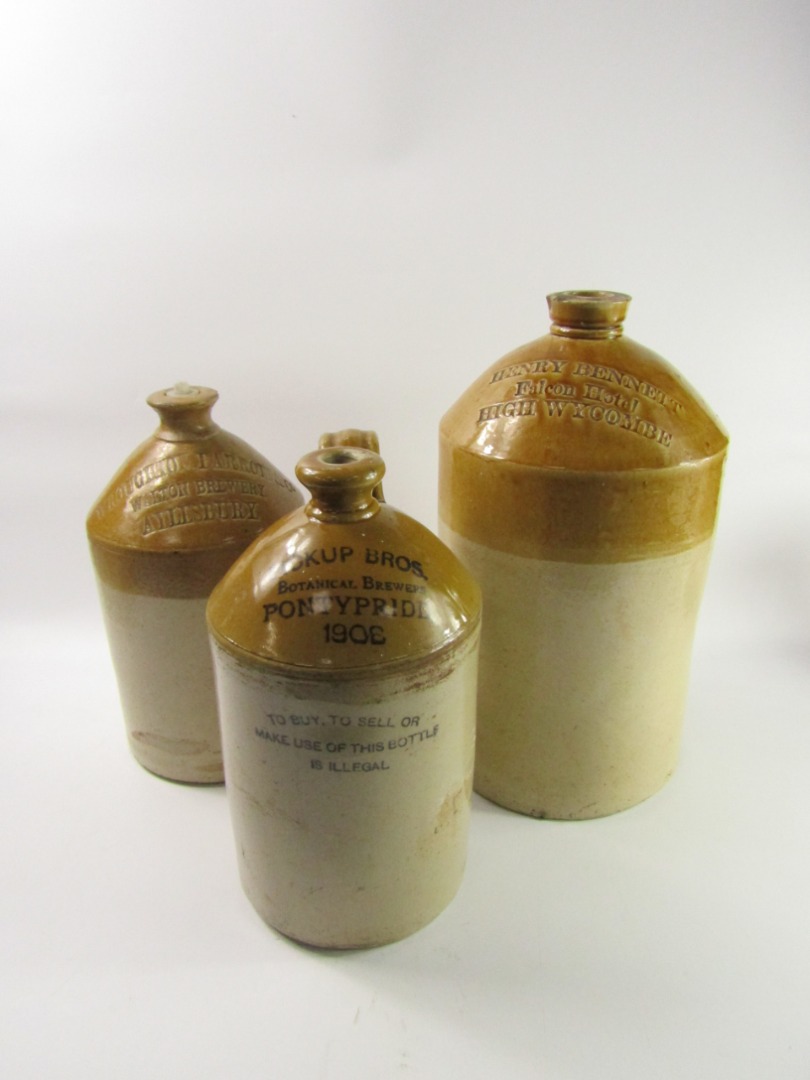 Appraisal: Three stoneware two tone spirit flagons Henry Bennett Falcon Hotel