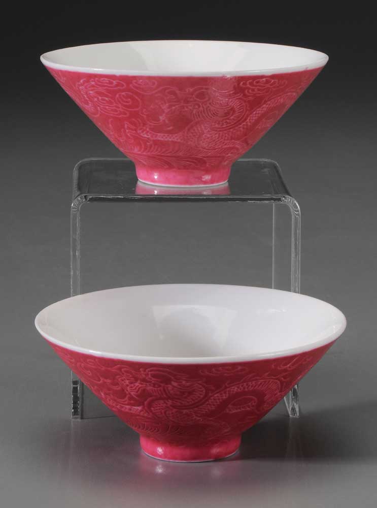 Appraisal: Pair Ruby-Ground Porcelain Bowls Chinese sgraffito dragons over waves bases