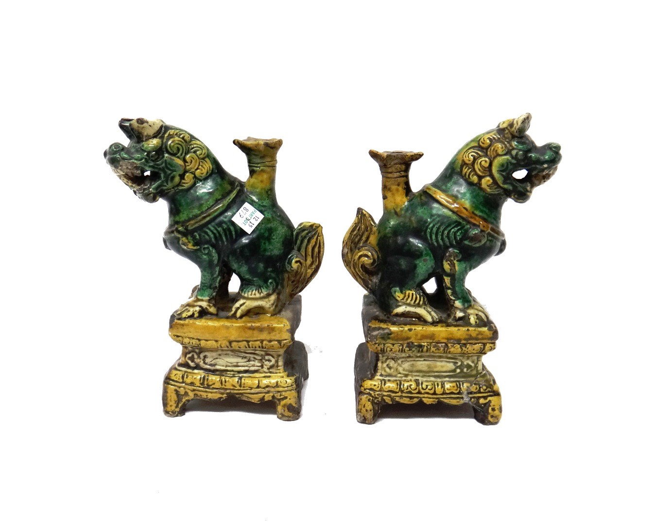 Appraisal: A pair of Chinese lion dog pottery tapersticks th th