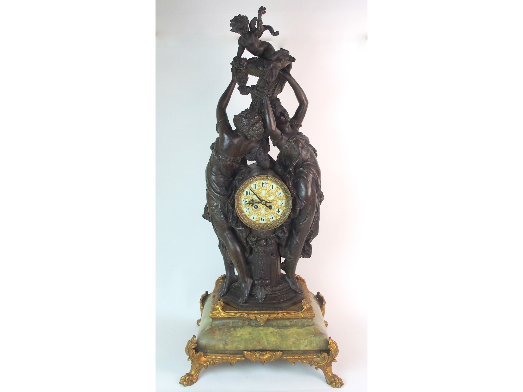 Appraisal: A French patinated spelter gilt bronze and onyx figural clockdepicting